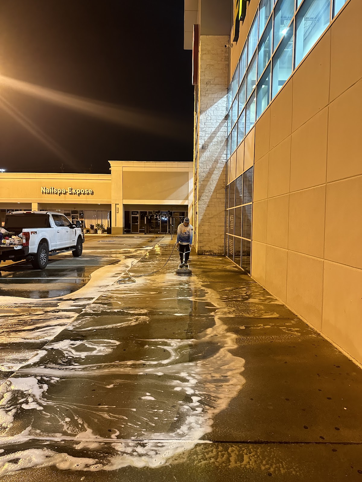 Our crew surface-cleaning a commercial walkway.